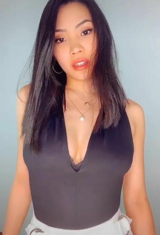 Sexy Tama Tomo Shows Cleavage in Black Bodysuit