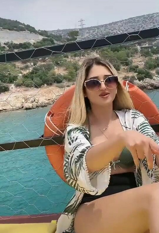 Hot Eda Aslankoç Shows Cleavage in Olive Bikini on a Boat