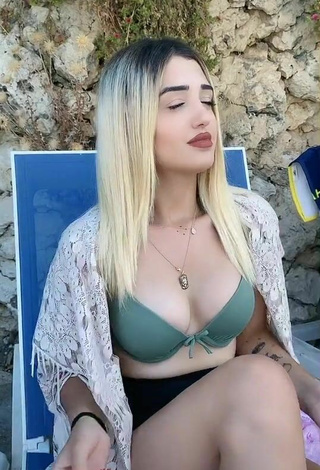 Hot Eda Aslankoç Shows Cleavage in Olive Bikini Top