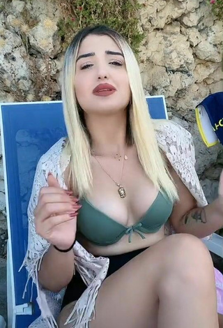 2. Hot Eda Aslankoç Shows Cleavage in Olive Bikini Top