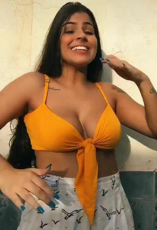 Attractive Julia Antunes Shows Cleavage in Yellow Crop Top