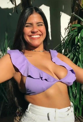 Julia Antunes Shows Cleavage in Appealing Purple Bikini Top