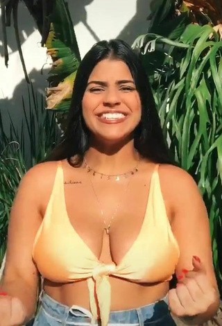 Julia Antunes Shows Cleavage in Inviting Yellow Bikini Top