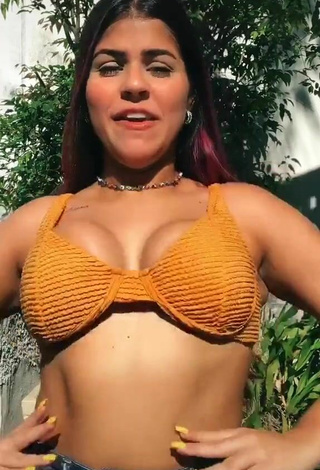 Julia Antunes Shows Cleavage in Sweet Orange Bikini Top