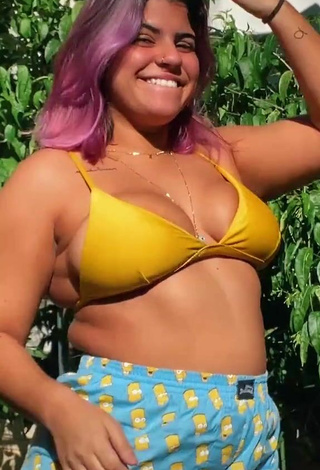 Cute Julia Antunes Shows Cleavage in Yellow Bikini Top
