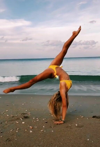 3. Gorgeous Olivia Dunne in Alluring Yellow Bikini at the Beach while doing Fitness Exercises