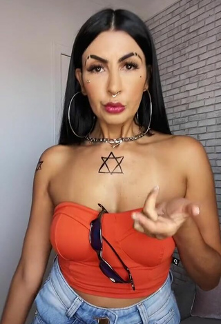 Sexy Sil Shows Cleavage in Electric Orange Tube Top