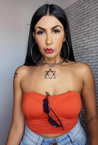 2. Sexy Sil Shows Cleavage in Electric Orange Tube Top