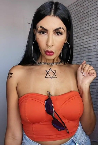 3. Sexy Sil Shows Cleavage in Electric Orange Tube Top