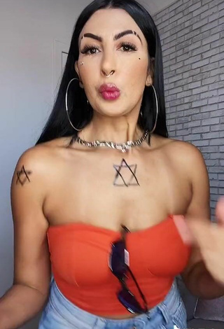4. Sexy Sil Shows Cleavage in Electric Orange Tube Top