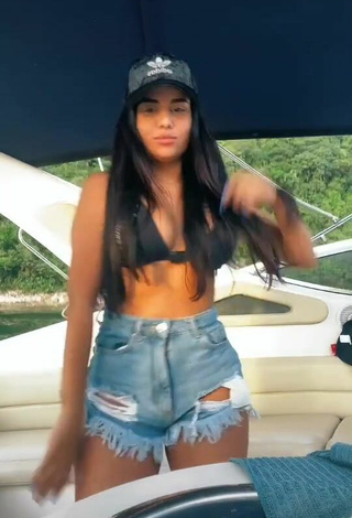 2. Beautiful Tati Nunes Shows Cleavage in Sexy Black Bikini Top on a Boat