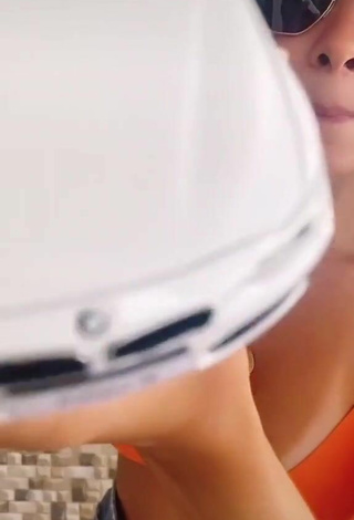 3. Cute Isadora Nogueira Shows Cleavage in Orange Bikini Top