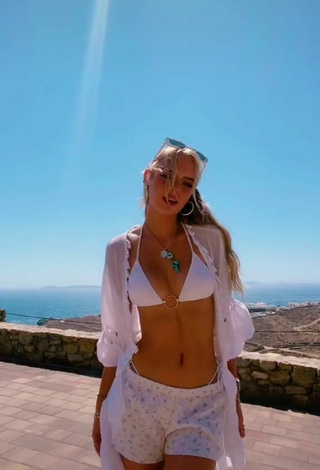 3. Sexy Jessica Belkin Shows Cleavage in White Bikini Top on the Balcony