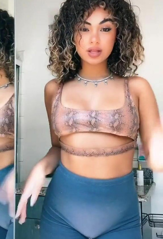 2. Attractive Devenity Perkins Shows Cleavage in Snake Print Crop Top