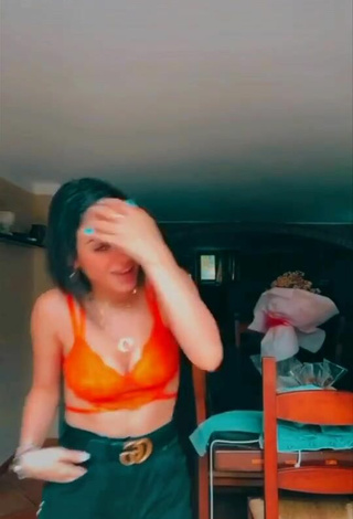 2. Sexy Giulia Paglianiti Shows Cleavage in Electric Orange Bra