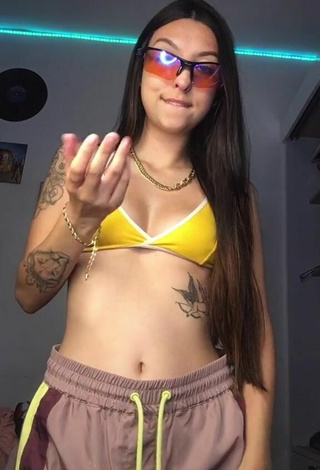 Julia Guerra Shows Cleavage in Inviting Yellow Bikini Top