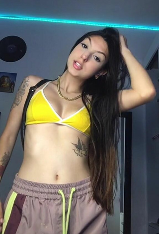 Julia Guerra Shows Cleavage in Seductive Yellow Bikini Top