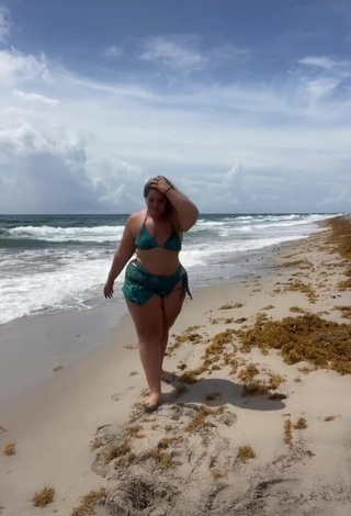 Erotic Sam Paige Shows Cleavage in Green Bikini at the Beach