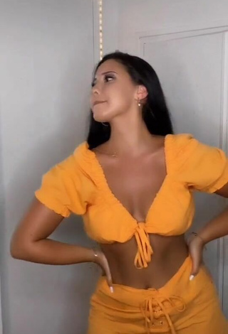 Wonderful Anissa Shows Cleavage in Orange Crop Top