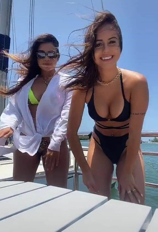 2. Seductive Bianca Jesuino Shows Cleavage in Black Bikini on a Boat