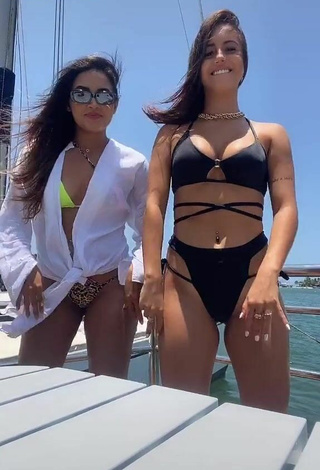 4. Seductive Bianca Jesuino Shows Cleavage in Black Bikini on a Boat