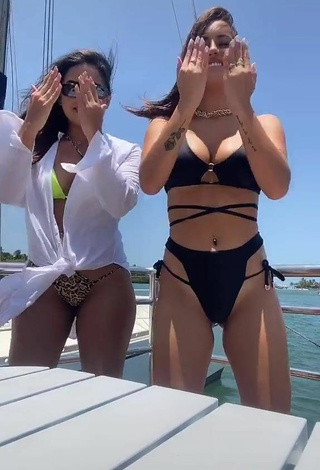 5. Seductive Bianca Jesuino Shows Cleavage in Black Bikini on a Boat