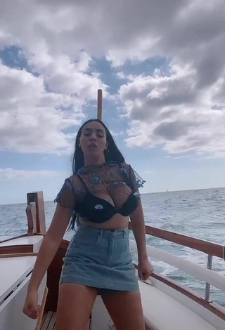 2. Sexy Carla Flila Shows Cleavage in Black Bra on a Boat