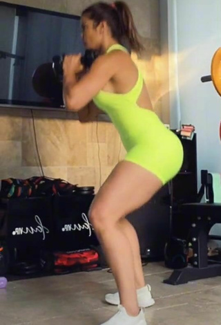 5. Sexy Laura Fuentes Shows Cleavage in Lime Green Overall while doing Fitness Exercises in the Sports Club