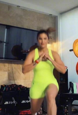 6. Sexy Laura Fuentes Shows Cleavage in Lime Green Overall while doing Fitness Exercises in the Sports Club