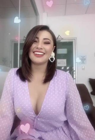 3. Seductive Milagro Flores Shows Cleavage in Purple Dress