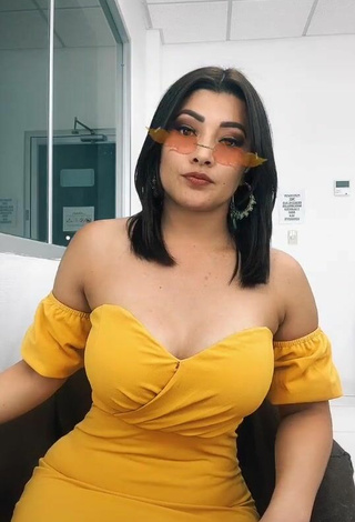 Erotic Milagro Flores Shows Cleavage in Yellow Dress