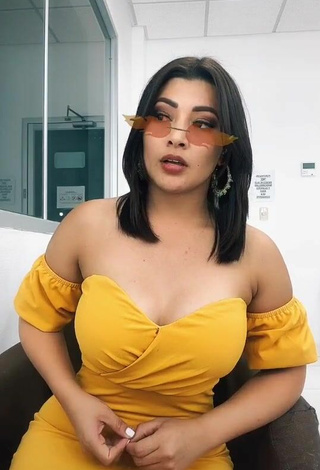 2. Erotic Milagro Flores Shows Cleavage in Yellow Dress