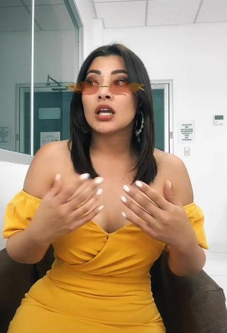 5. Erotic Milagro Flores Shows Cleavage in Yellow Dress