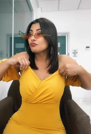 6. Erotic Milagro Flores Shows Cleavage in Yellow Dress