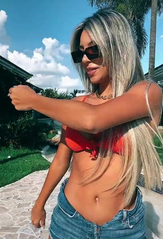 2. Erotic Raffaela Souza Shows Cleavage in Orange Bikini Top