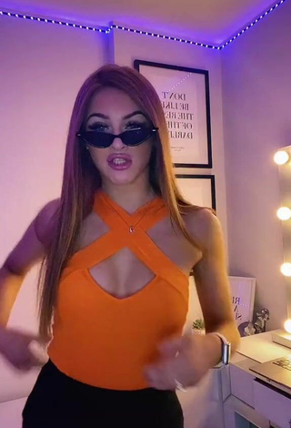 2. Sexy Sophie Aspin Shows Cleavage in Orange Top
