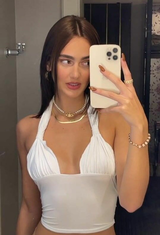 5. Sexy Suede Brooks Shows Cleavage in White Crop Top