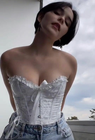 3. Cute Angelique Shows Cleavage in White Corset on the Balcony