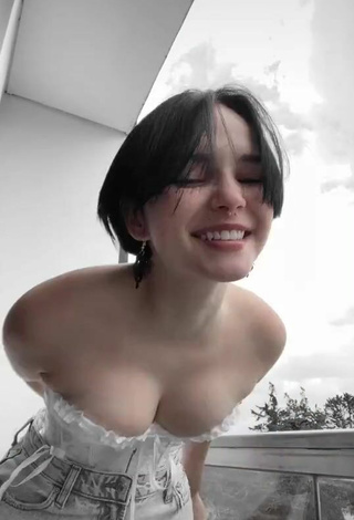 2. Hot Angelique Shows Cleavage in White Corset on the Balcony