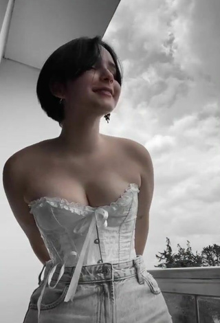 3. Hot Angelique Shows Cleavage in White Corset on the Balcony