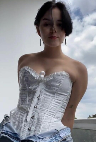 2. Sexy Angelique Shows Cleavage in White Corset on the Balcony