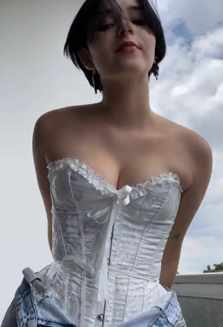 3. Sexy Angelique Shows Cleavage in White Corset on the Balcony