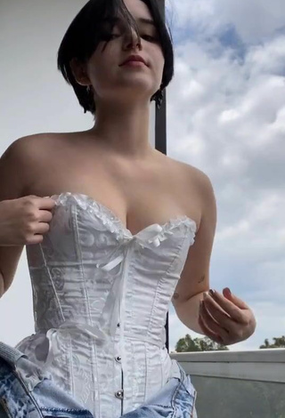 5. Sexy Angelique Shows Cleavage in White Corset on the Balcony