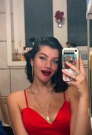 3. Sexy Bleue Shows Cleavage in Red Dress