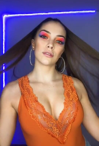 Sexy Azul Granton Shows Cleavage in Orange Top
