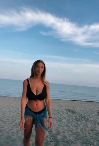 2. Sexy Susanna Bonetto Shows Cleavage in Black Bikini Top at the Beach