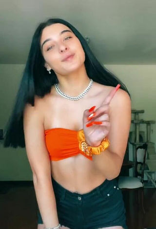 Sexy Sofia Crisafulli Shows Cleavage in Orange Tube Top