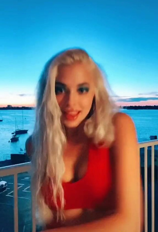 6. Wonderful Bella Martinez Shows Cleavage in Red Crop Top on the Balcony