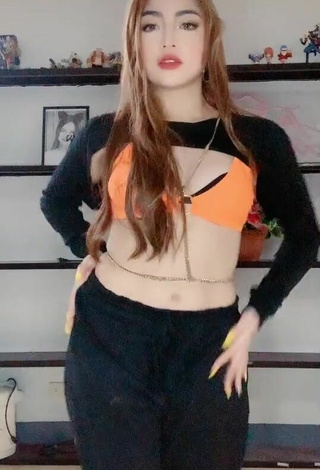 2. Sexy Lea Jane Shows Cleavage in Orange Bikini Top