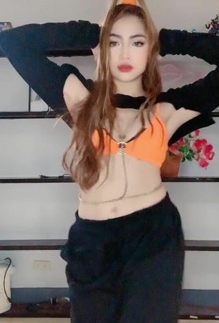 3. Sexy Lea Jane Shows Cleavage in Orange Bikini Top